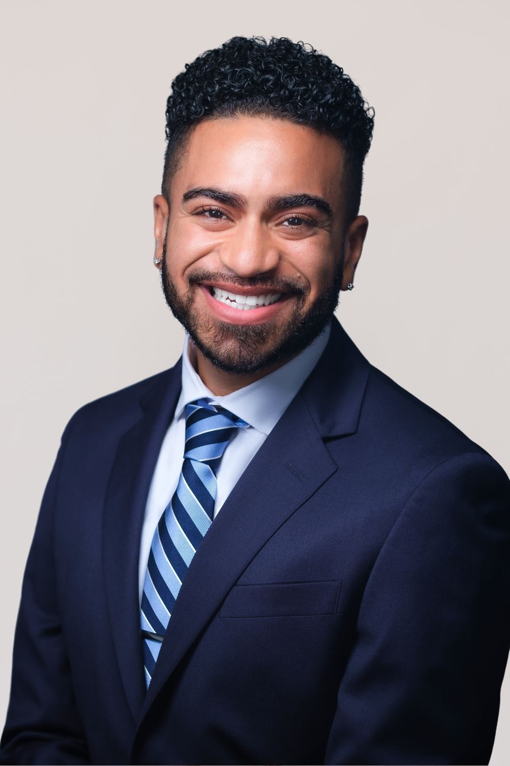 Smiling professional in suit and tie.