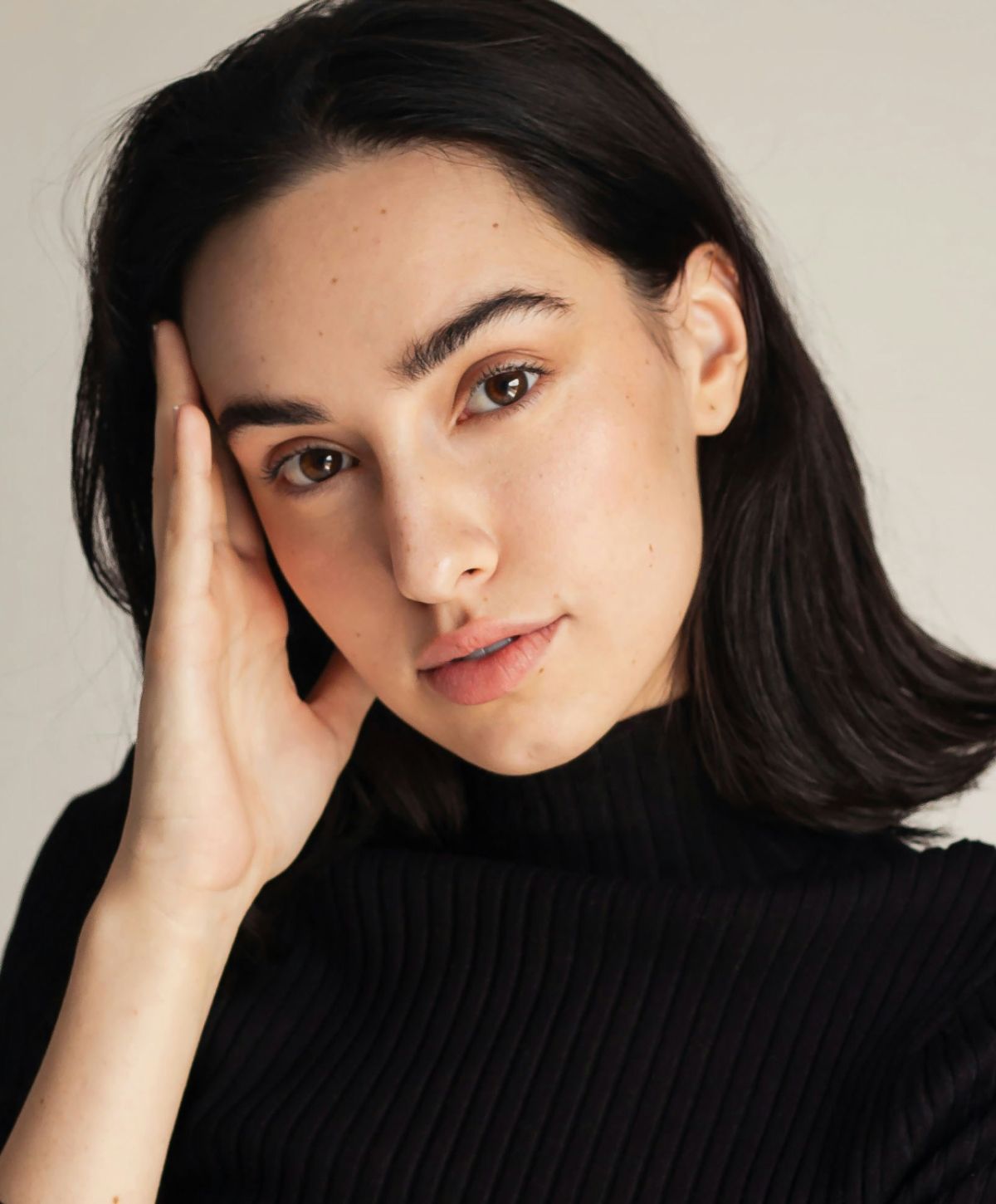 Portrait of a young woman in black sweater.