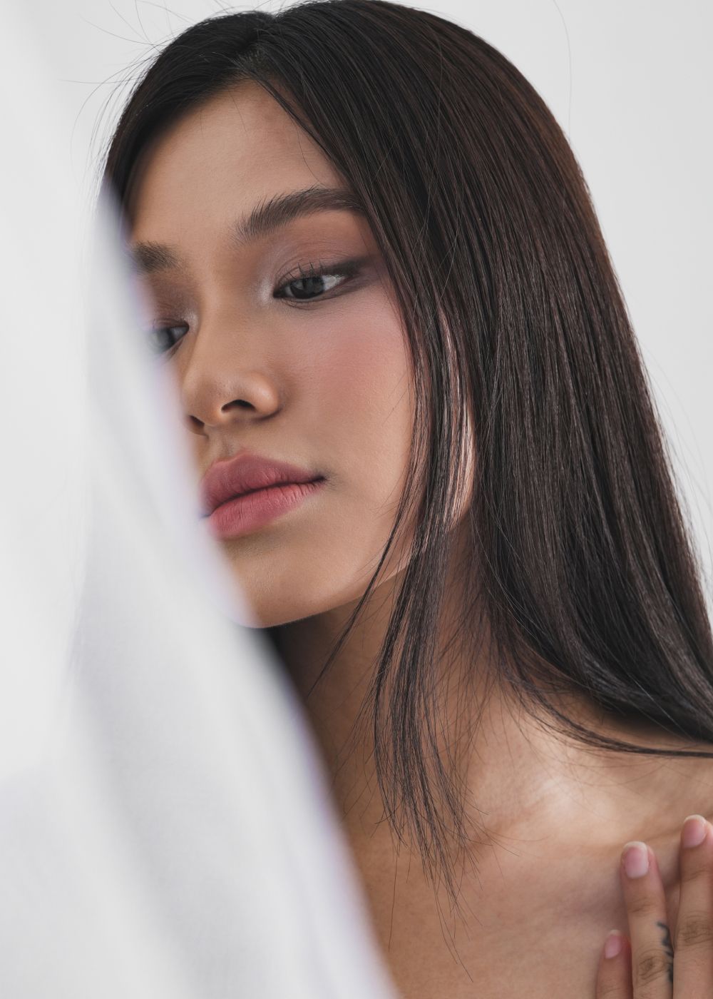 Close-up of a woman with long dark hair.