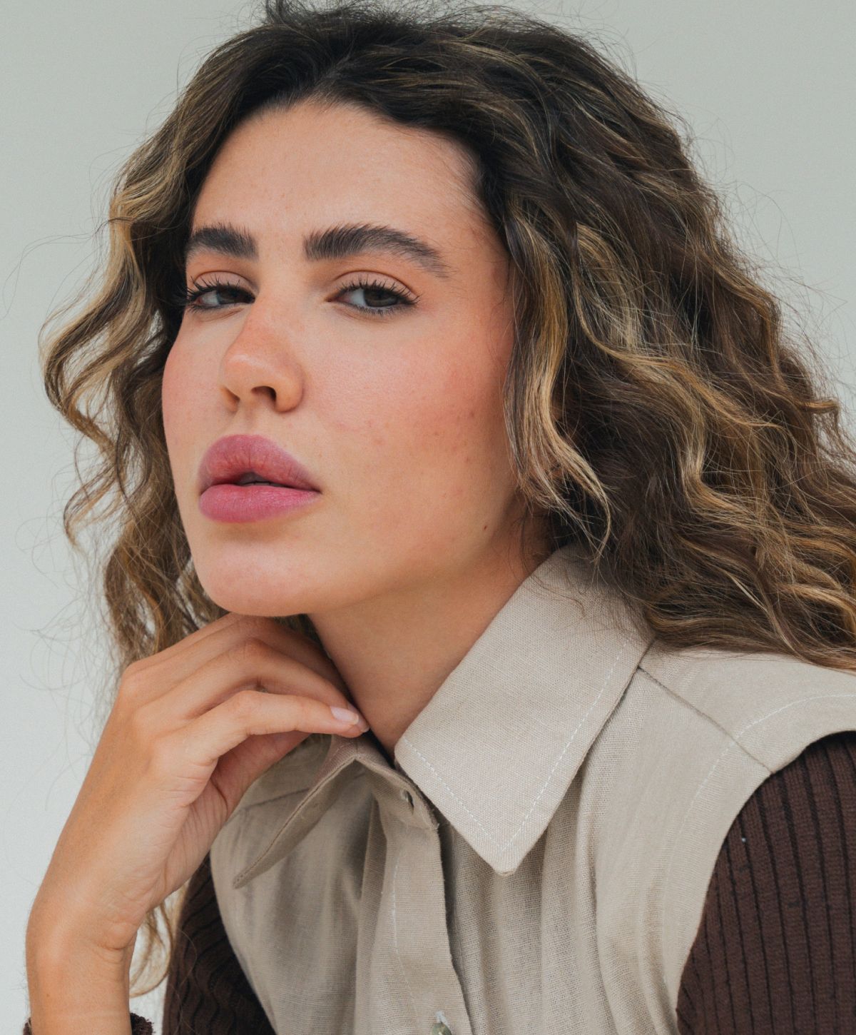 Close-up of a woman with curly hair.