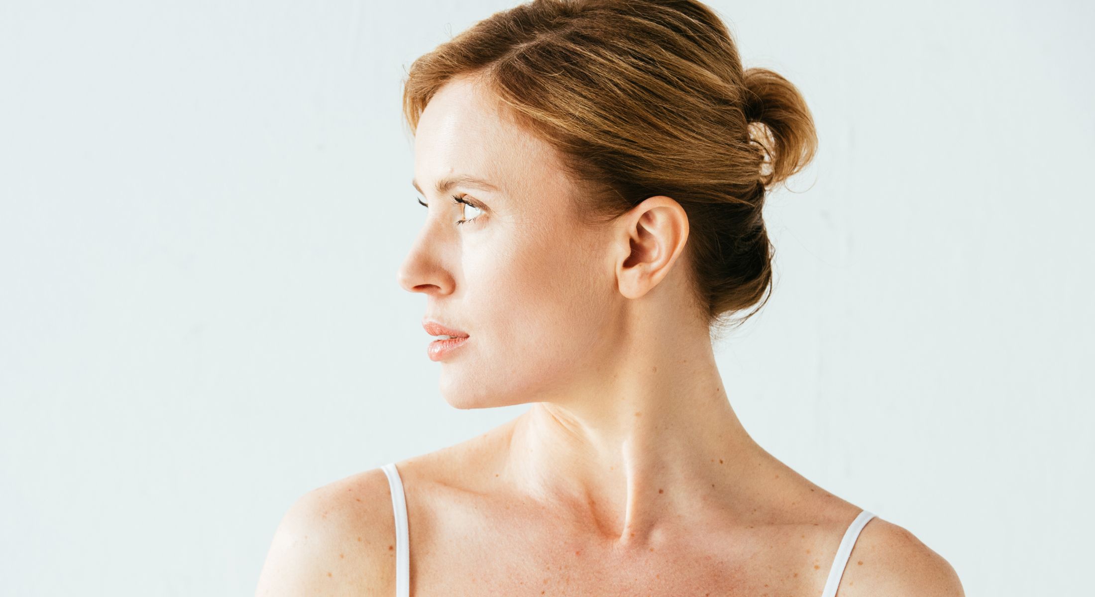 Profile of a woman with light background.